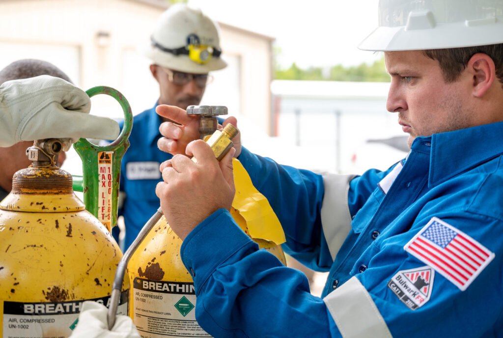 Team Services employee inspecting safety protocols in marine and facility services.